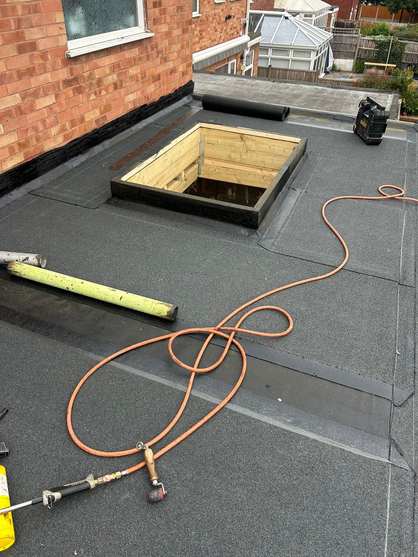 Installed bituminous roofing membrane within flat roof waterproofing system