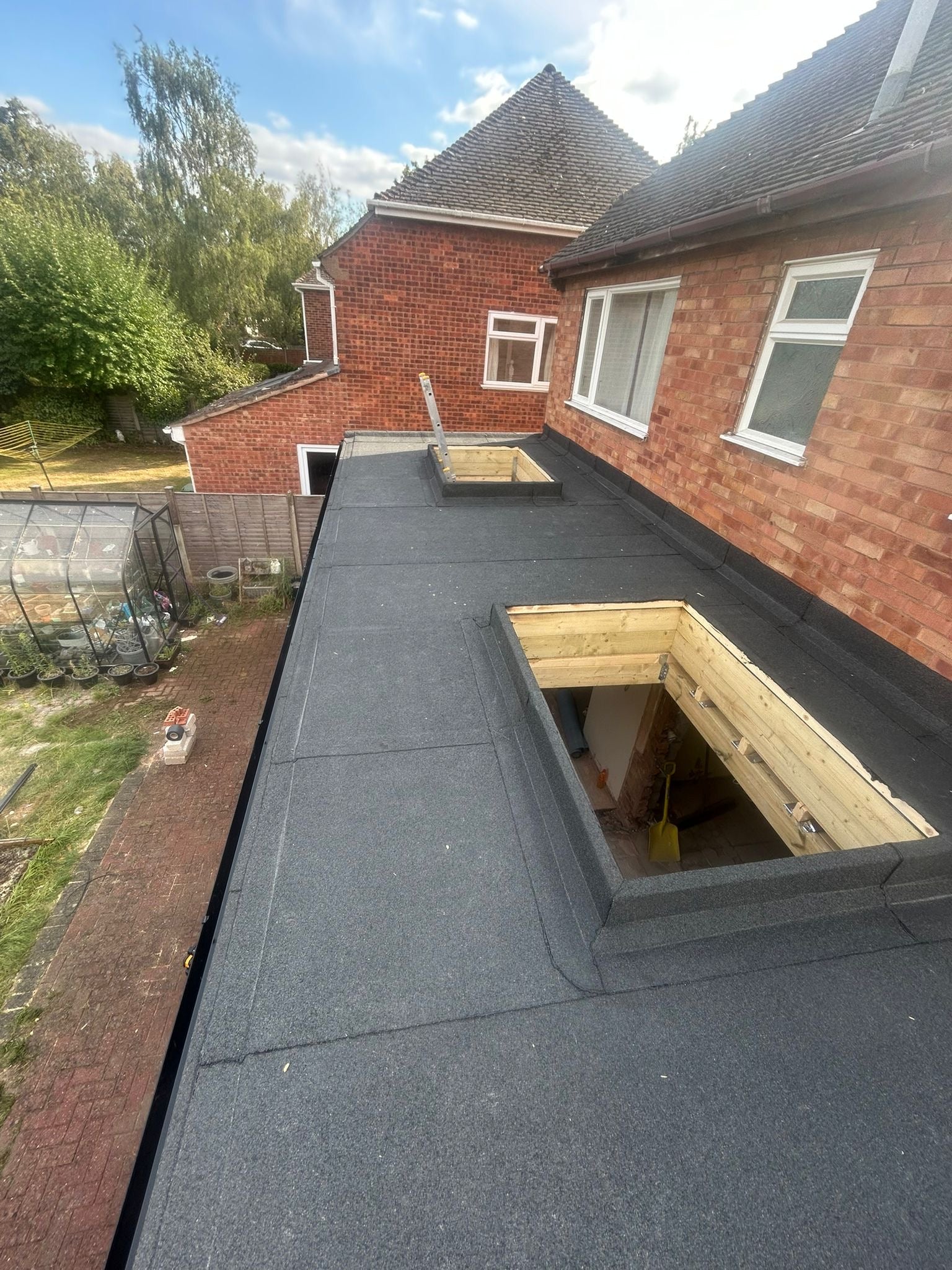 Installed bituminous roofing membrane within flat roof waterproofing system
