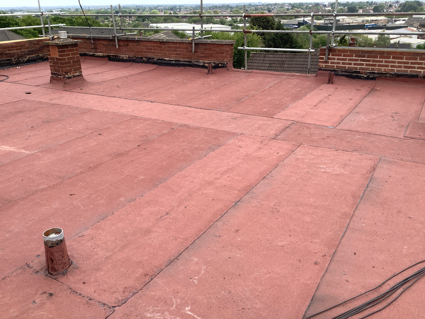 Installed bituminous AVCL roofing membrane within flat roof system