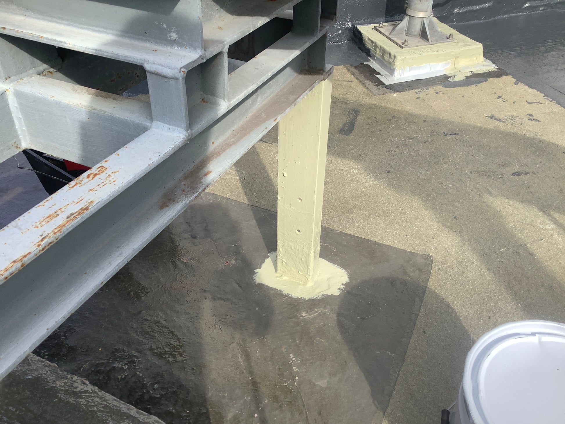 Structural steel roof support primed with Vanquish 2K Metal Primer to improve waterproofing adhesion