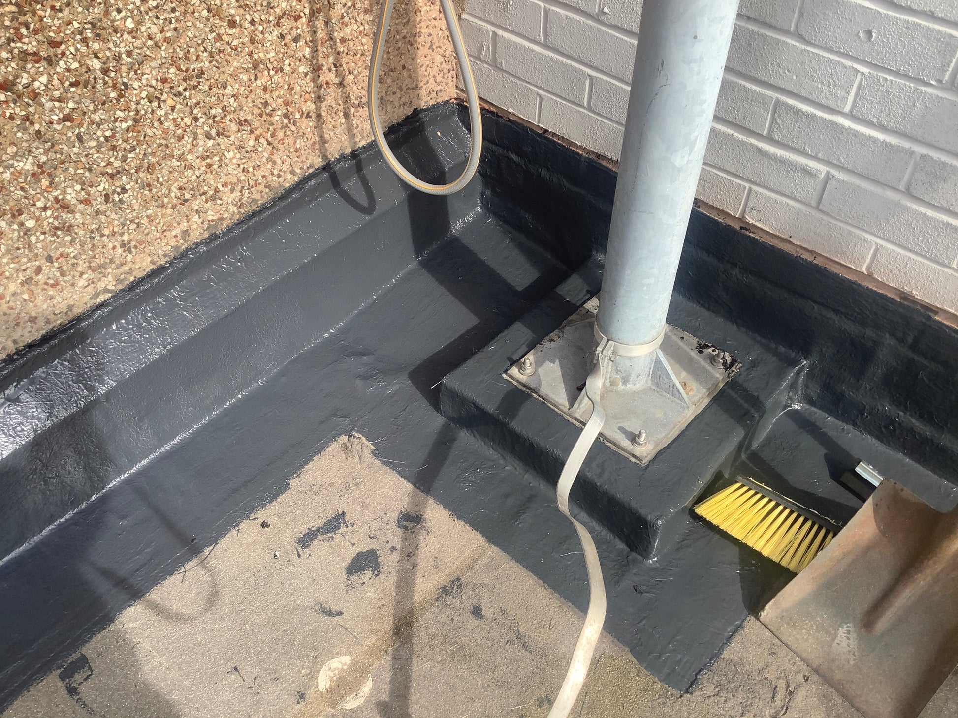 polyurethane roof coating applied to flat roof waterproofing system