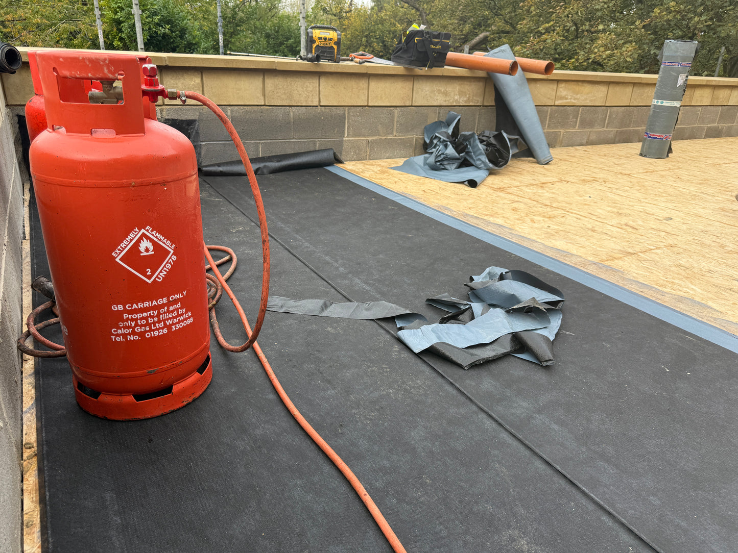 Installed bituminous AVCL roofing membrane within flat roof system waterproofing