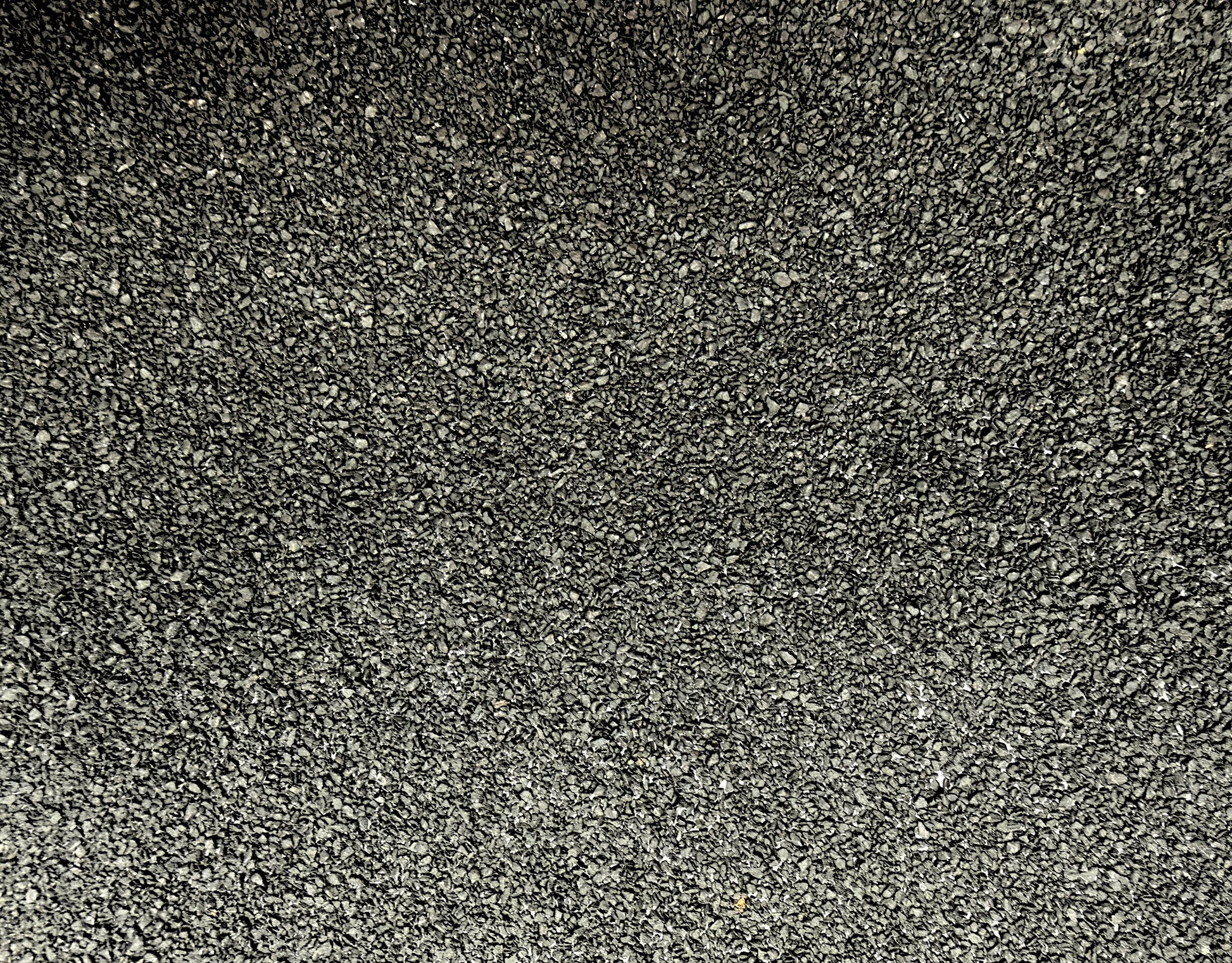 Close-up of the mineral-finished slate surface used on Vanquish Pro SBS torch-on roofing felt, providing long-term UV protection and durability for flat roofing systems.
