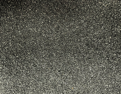 Close-up of the mineral-finished slate surface used on Vanquish Pro SBS torch-on roofing felt, providing long-term UV protection and durability for flat roofing systems.